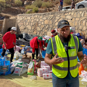 A photograph of relief workers distributing essential supplies to needy families in Morocco.