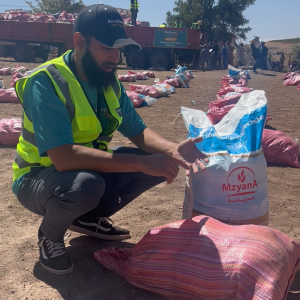 Blackburn UK Trust's relief team members distribute food packages to families in Morocco.